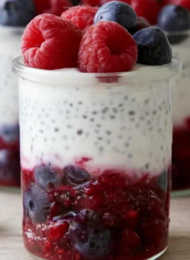 Berry & Chia Yogurt Parfait with fresh fruits and yogurt in a clear glass