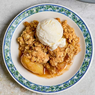 Delicious homemade apple crumble served in a cozy dish.