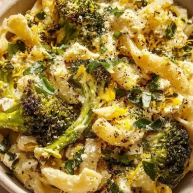 Cozy baked feta pasta with broccoli in a creamy sauce, served in a bowl.
