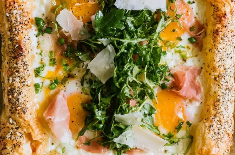 Cozy baked prosciutto and egg breakfast tart on a wooden table