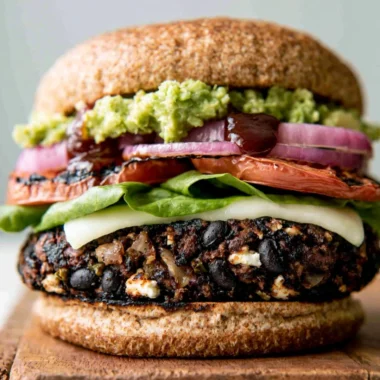 Cozy black bean burgers served with fresh toppings and a side of salad