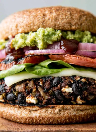 Cozy black bean burgers served with fresh toppings and a side of salad