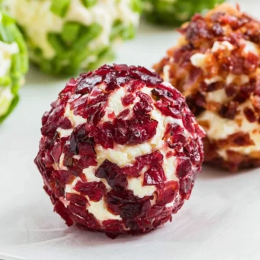 Cozy mini cheeseball bites served on a platter with toppings