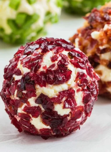 Cozy mini cheeseball bites served on a platter with toppings