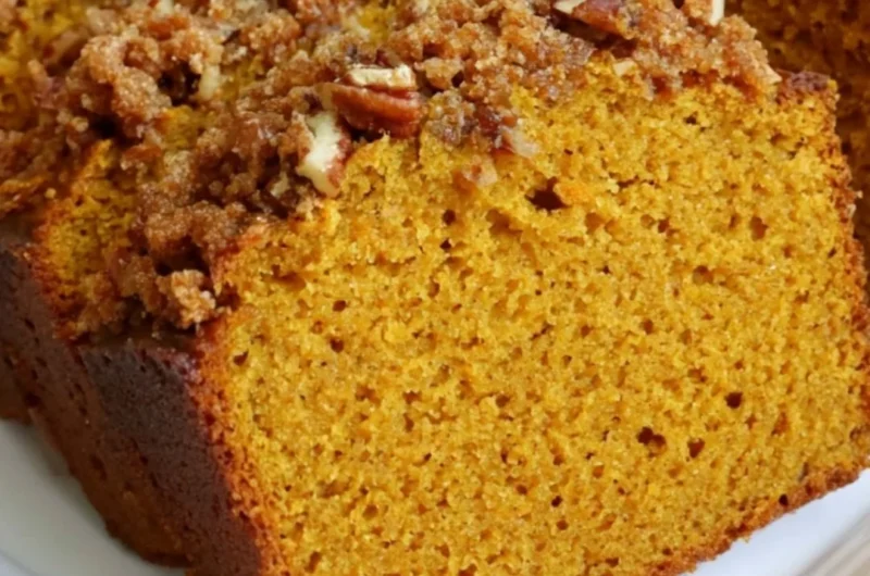 Delicious homemade pumpkin bread topped with spices and nuts