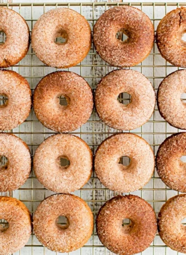 Cozy pumpkin spice donuts topped with icing and sprinkled with cinnamon.