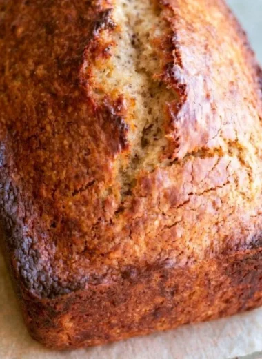 Loaf of easy homemade banana bread with sliced bananas on top