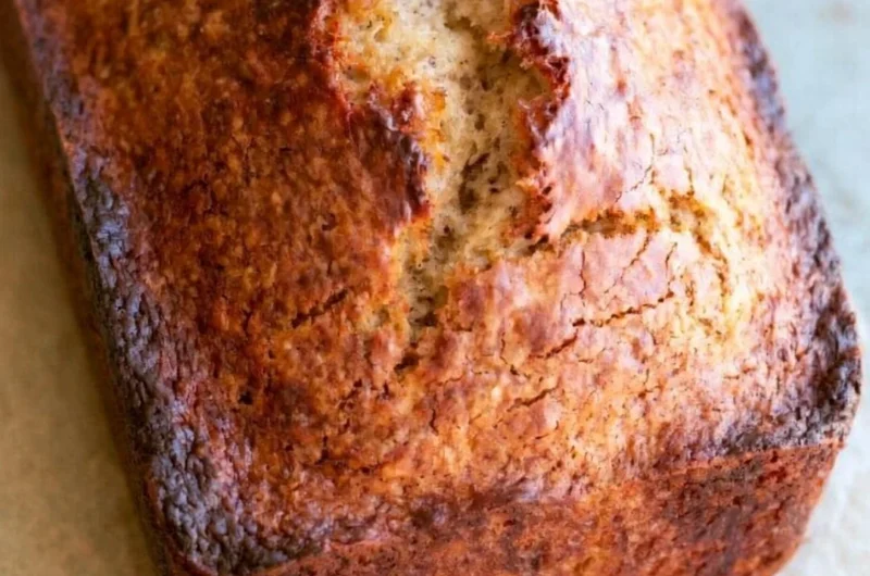 Loaf of easy homemade banana bread with sliced bananas on top
