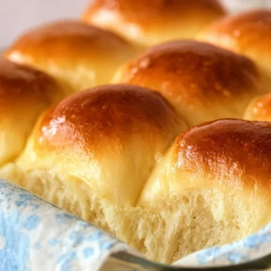 Freshly baked Grandma's buttery dinner rolls on a wooden table