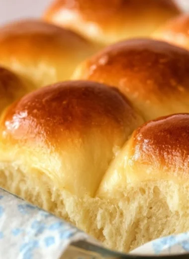 Freshly baked Grandma's buttery dinner rolls on a wooden table