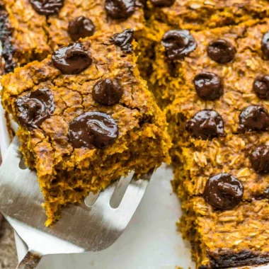 Delicious pumpkin baked oatmeal topped with chocolate chips in a rustic bowl