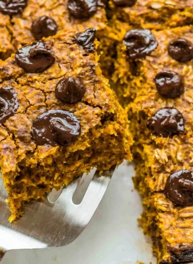 Delicious pumpkin baked oatmeal topped with chocolate chips in a rustic bowl