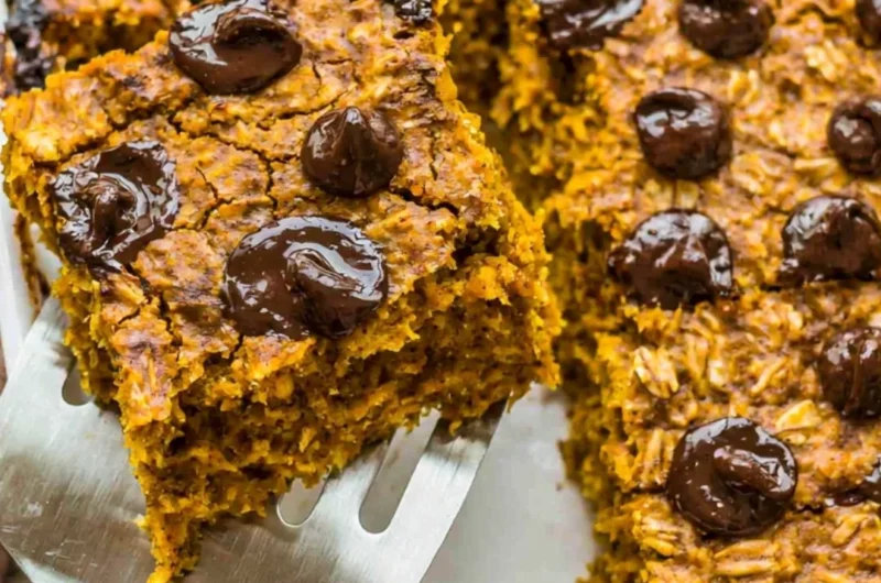 Delicious pumpkin baked oatmeal topped with chocolate chips in a rustic bowl