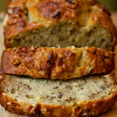 Slice of Bourbon Banana Walnut Bread with walnuts and banana pieces