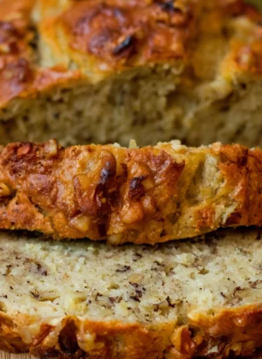 Slice of Bourbon Banana Walnut Bread with walnuts and banana pieces