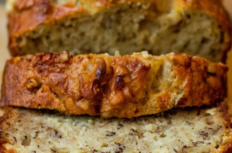 Slice of Bourbon Banana Walnut Bread with walnuts and banana pieces