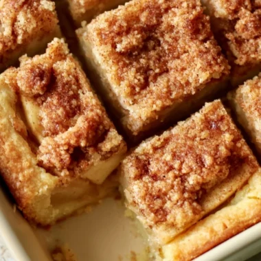 Cozy apple pie bars with fresh apples and cinnamon on a rustic wooden table
