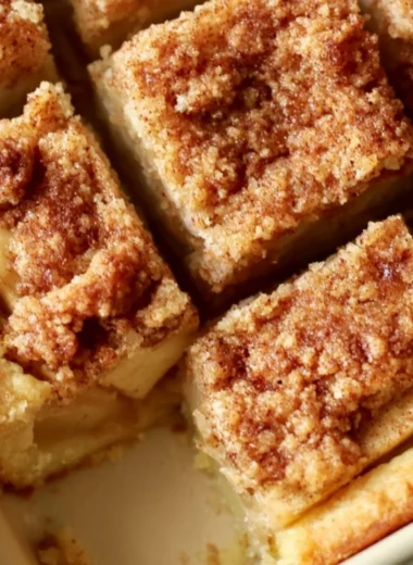 Cozy apple pie bars with fresh apples and cinnamon on a rustic wooden table