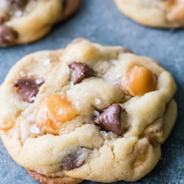 Freshly baked chocolate chip salted caramel cookies on a cooling rack