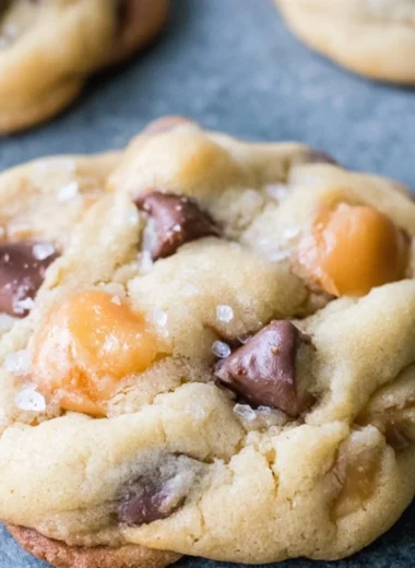 Freshly baked chocolate chip salted caramel cookies on a cooling rack