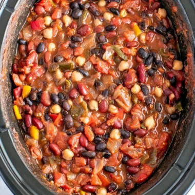 Bowl of cozy slow cooker vegetarian chili with fresh ingredients