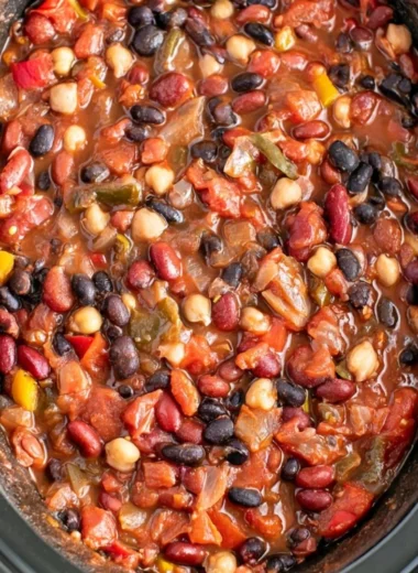 Bowl of cozy slow cooker vegetarian chili with fresh ingredients