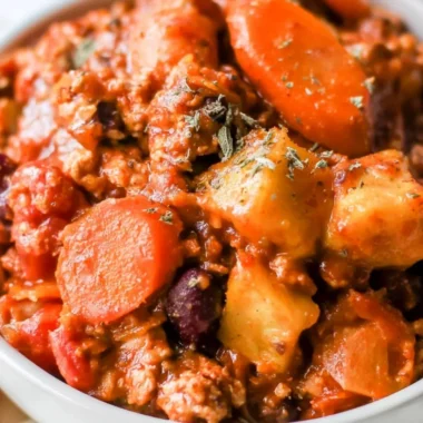 Bowl of cozy Turkey Apple Chili topped with fresh herbs.