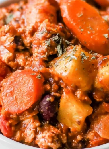 Bowl of cozy Turkey Apple Chili topped with fresh herbs.