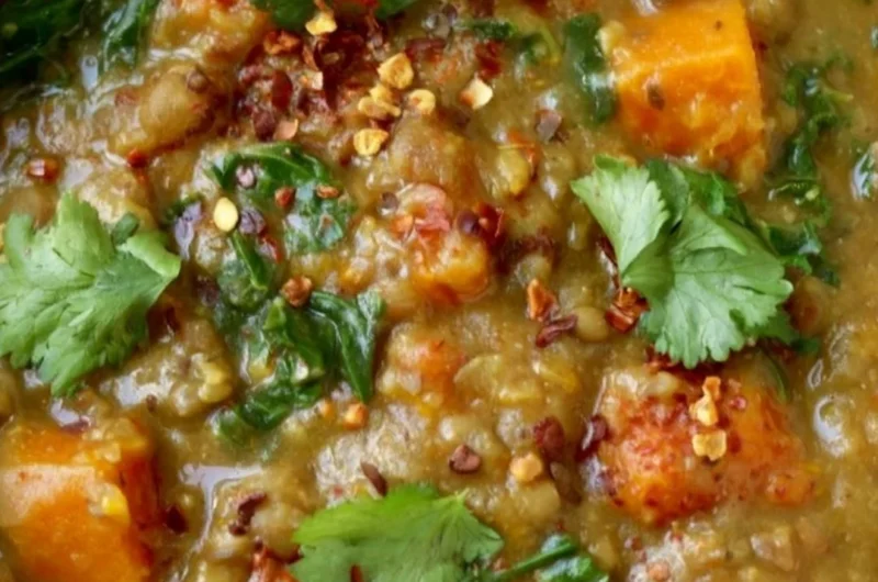 Bowl of earthy Moroccan sweet potato lentil stew with spices and vegetables