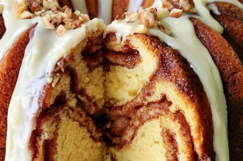 Easy Cinnamon Roll Bundt Cake with icing on a white cake stand