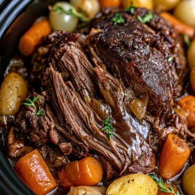 Delicious cozy crockpot pot roast served with veggies in a warm bowl.