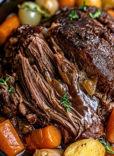 Delicious cozy crockpot pot roast served with veggies in a warm bowl.