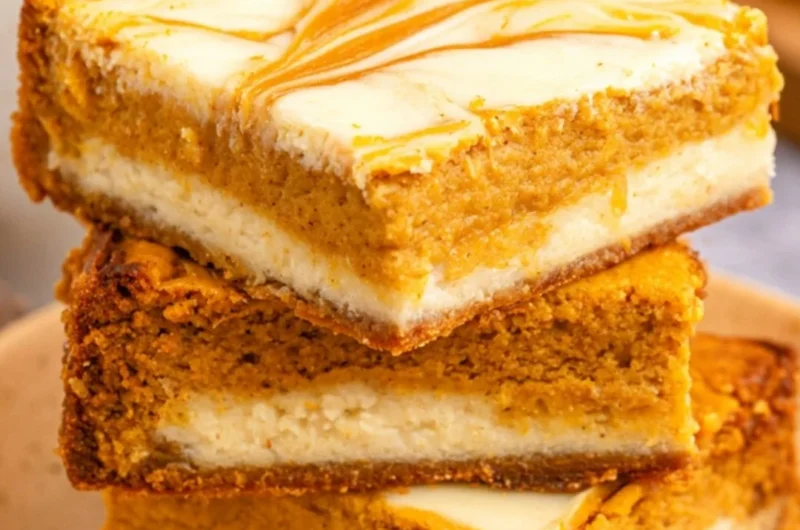 Cozy pumpkin cream cheese cheesecake bars topped with autumn spices.