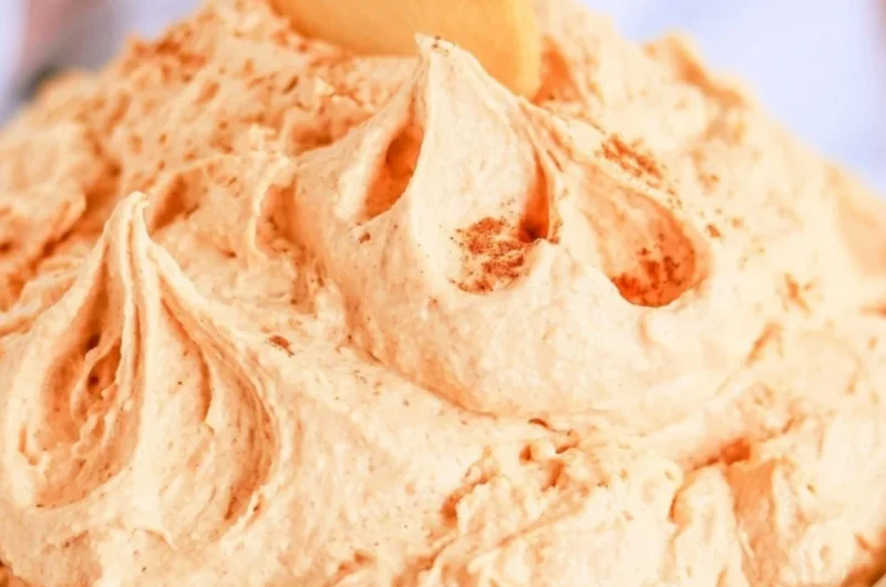 Delicious pumpkin cheesecake dip served in a bowl with graham crackers nearby.