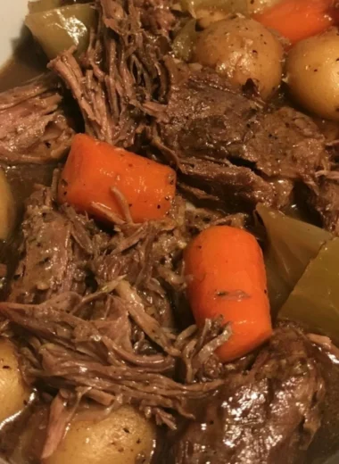 Delicious slow cooker pot roast with vegetables in a rustic dish