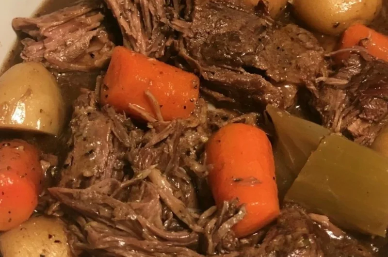 Delicious slow cooker pot roast with vegetables in a rustic dish