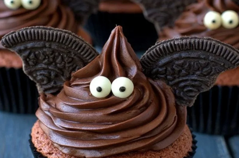 Halloween bat cupcakes decorated with chocolate and candy for a spooky treat.