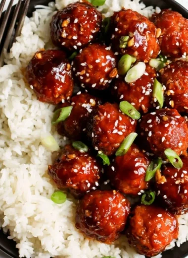 Delicious honey garlic meatballs served with sauce in a bowl.