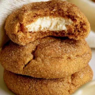 Chewy pumpkin cheesecake cookies with a creamy filling and fall spices