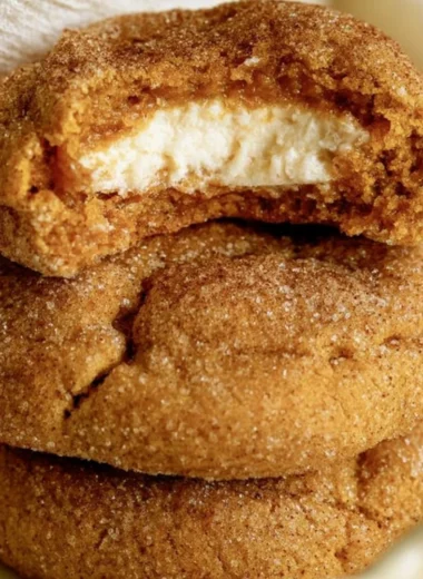 Chewy pumpkin cheesecake cookies with a creamy filling and fall spices