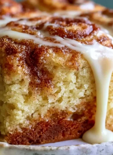 Delicious Cinnabon cinnamon roll cake topped with creamy icing