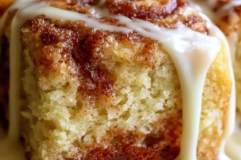 Delicious Cinnabon cinnamon roll cake topped with creamy icing