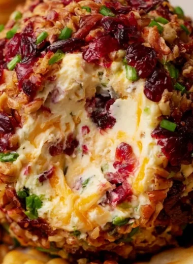 Cranberry pecan cheese ball served with crackers and fruits