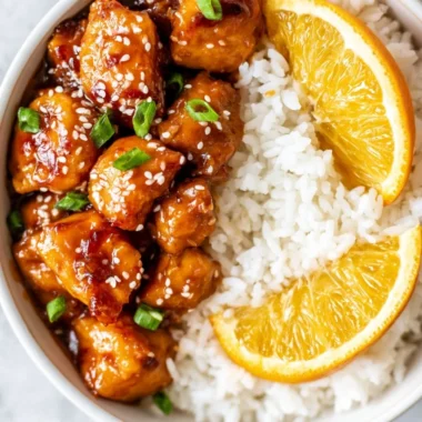 Healthy orange chicken bowl served with vegetables and rice, perfect for a quick meal.