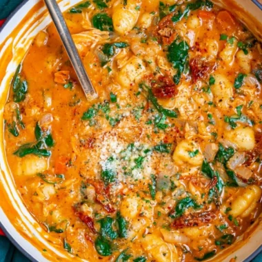 Bowl of delicious Italian chicken gnocchi soup with vegetables and spices.
