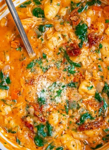 Bowl of delicious Italian chicken gnocchi soup with vegetables and spices.