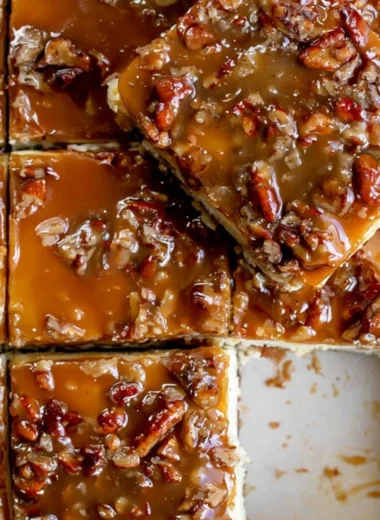 Delicious pecan pie cheesecake bars topped with caramel and pecans