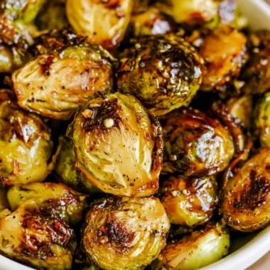 Roasted Brussels sprouts with honey balsamic sauce on a white plate