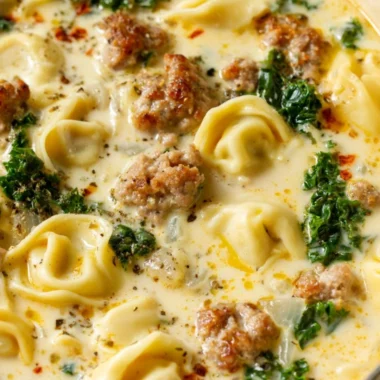 Bowl of delicious Sausage Tortellini Soup with fresh herbs