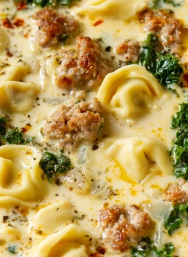 Bowl of delicious Sausage Tortellini Soup with fresh herbs